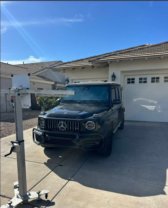 One Stop Auto Glass technician installing a new windshield on a Mercedes G-Wagon in Phoenix, Arizona
